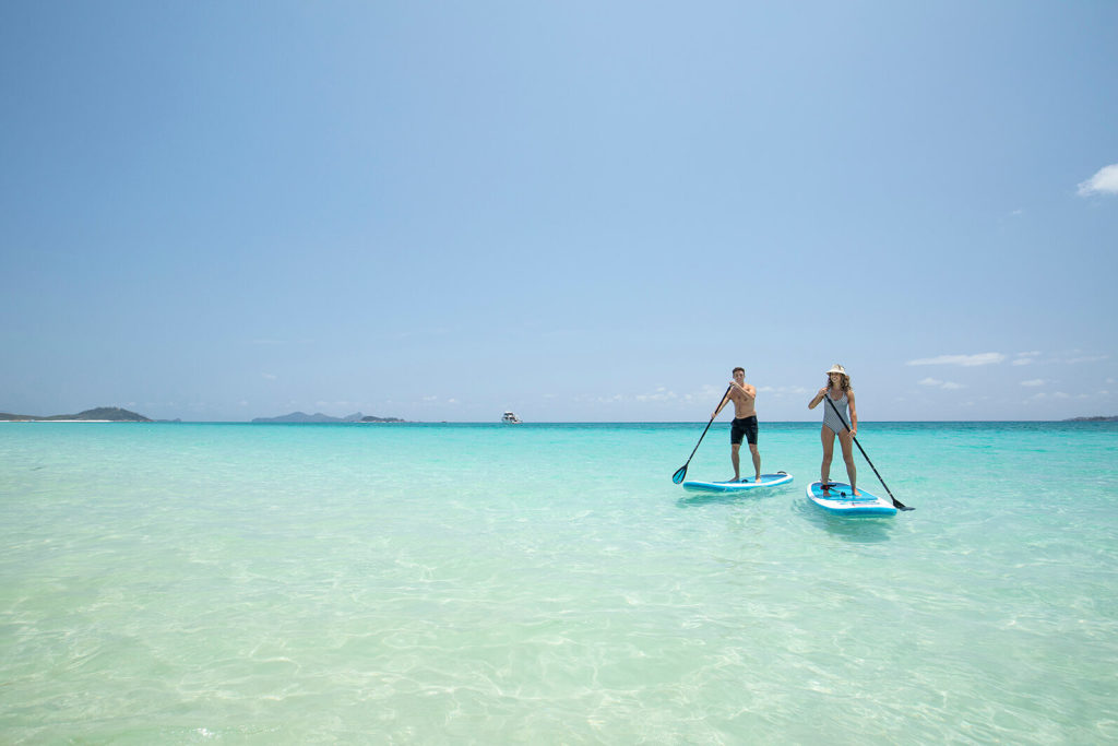 stand up paddleboard couple escape holiday